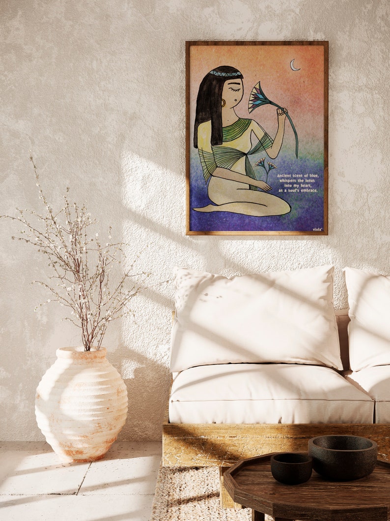 May include: A watercolor illustration of a woman in a yellow robe holding a blue lotus flower. The background is a gradient of orange, pink, and blue. The text reads "Ancient scent of blue, whispers the lotus into my heart, as a soul's embrace."