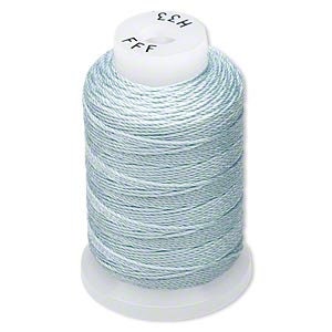 May include: A spool of light blue thread with a white plastic base and top. The thread is tightly wound around the spool. The top of the spool has the text "H33" and "FFF".