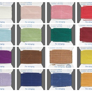 May include: A collection of 16 spools of nylon cord in various colors, including white, pink, red, teal, green, burgundy, purple, brown, gold, blue, and yellow. Each spool is labeled "For stringing".
