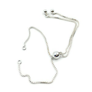 May include: A silver chain bracelet with a sliding bead closure. The chain is made of small, linked circles and the bead is round and smooth.