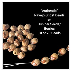 May include: A close-up of 10 or 20 brown and white "Authentic" Navajo Ghost Beads or Juniper Seeds/Berries. The beads are strung on a white thread.