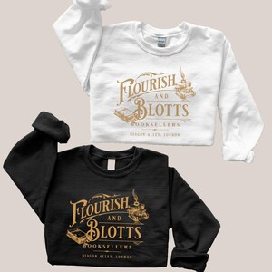 May include: Two sweatshirts with a gold graphic of the fictional bookstore "Flourish and Blotts" from the Harry Potter series. The text reads "Flourish and Blotts Booksellers Diagon Alley, London". One sweatshirt is white and the other is black.