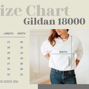 May include: A size chart for Gildan 18000 sweatshirts. The chart shows measurements in inches for sizes S through 4XL. A person is wearing a white sweatshirt and blue jeans. The chart includes length and width measurements.