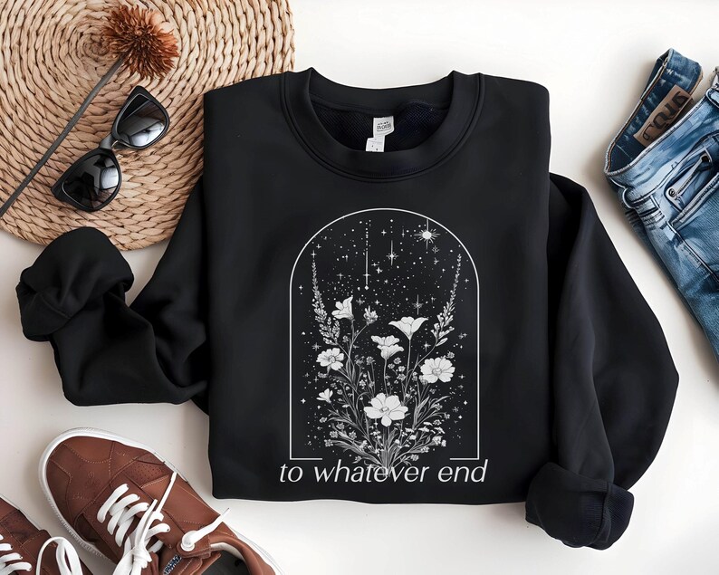 May include: Black sweatshirt with a white floral design and the text "to whatever end" printed on the front.