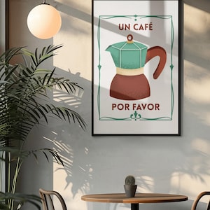Può includere: Un poster incorniciato con un'illustrazione di caffettiera. La caffettiera è marrone e verde acqua, con le parole "UN CAFÉ POR FAVOR" in testo bianco. Il poster è in una cornice nera, appeso a una parete bianca. Un tavolo rotondo e sedie sono di fronte al poster.