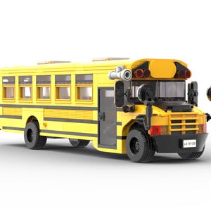 May include: A yellow toy school bus with black wheels, a black door, and a black number plate that reads "LS 18 128".