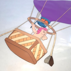 May include: An animated image of a light-skinned pony with pink hair in a hot air balloon. The balloon has a purple top and a brown basket. The pony is holding a pencil and appears to be drawing.