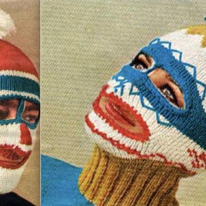 May include: Two knitted ski masks with face designs. One is red, white, and blue with a pom-pom. The other is white, blue, and gold with a pom-pom. The masks have eye and mouth openings.