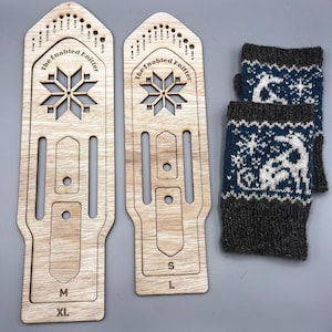 May include: Two wooden knitting tools with the text "The Enabled Knitter" and a snowflake design, labeled M, XL, S, and L. Two blue, white, and gray knitted fingerless gloves with a reindeer pattern are also shown.