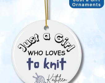 May include: White ceramic ornament with the text "Just a Girl Who Loves to Knit" in black and blue lettering. A small illustration of knitting needles and yarn is below the text, with the name "Kathleen" written underneath.