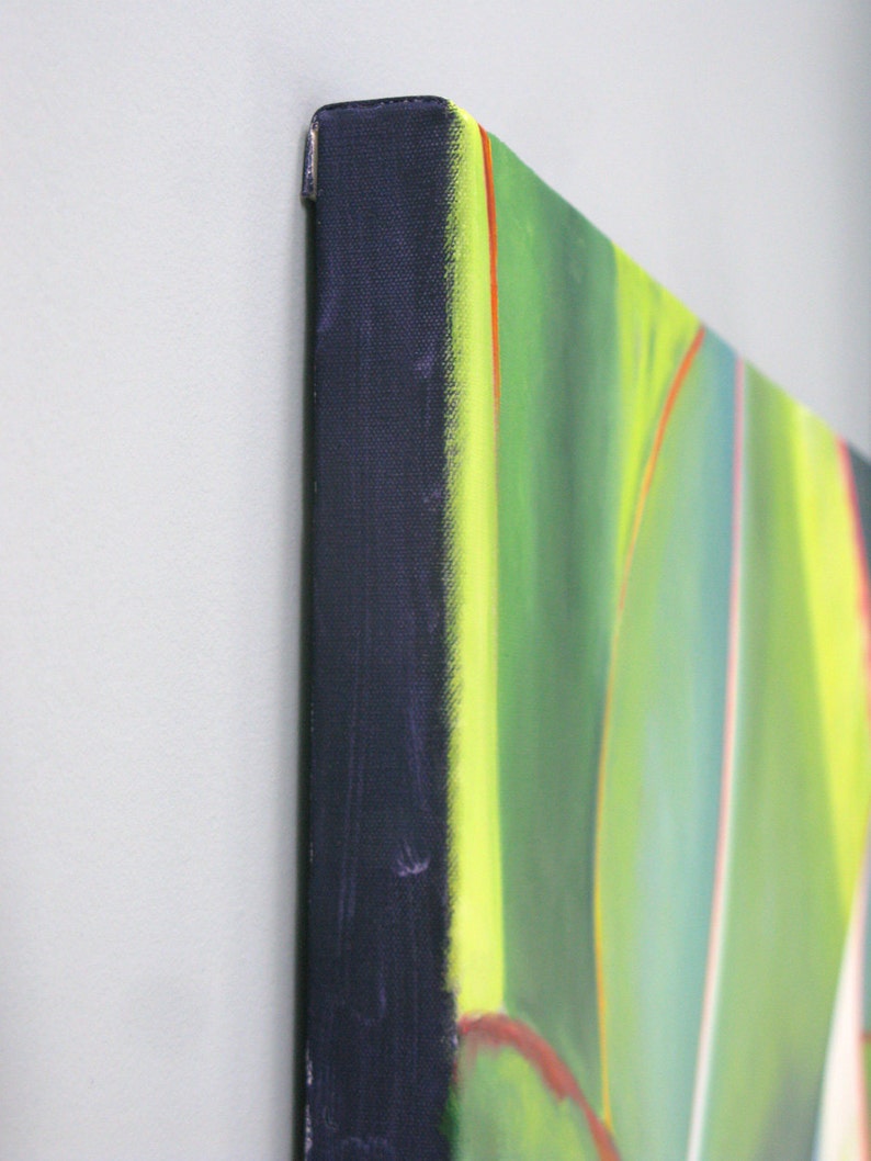 May include: Close-up of a canvas art piece with a vibrant abstract design. The artwork features a palette of green, yellow, and red hues. The canvas edges are wrapped in a dark blue fabric, creating a clean, finished look.