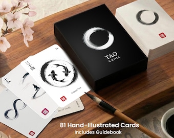 May include: A black box of "TAO Cards" with a white circular design and a stack of cards with black and white illustrations. The cards feature Chinese characters and the text "Endless Flow" and "Way of Truth". The image also includes a paintbrush.