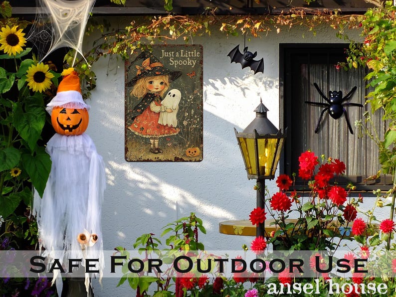May include: Halloween-themed outdoor decorations. A pumpkin-headed figure in a white sheet, a metal sign with a witch and ghost, and a black bat and spider. The sign reads "Just a Little Spooky."