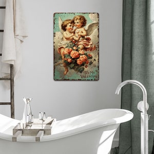 May include: Vintage Valentine's Day sign featuring two cherubs with wings holding a bouquet of pink roses. The sign has a distressed, rusty metal look and reads "To My Valentine".