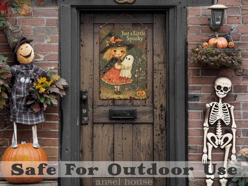 May include: A vintage-style Halloween sign with a witch and ghost illustration hangs on a wooden door. The sign reads "Just a Little Spooky." A scarecrow, pumpkins, and a skeleton decorate the porch, creating a festive autumn scene.