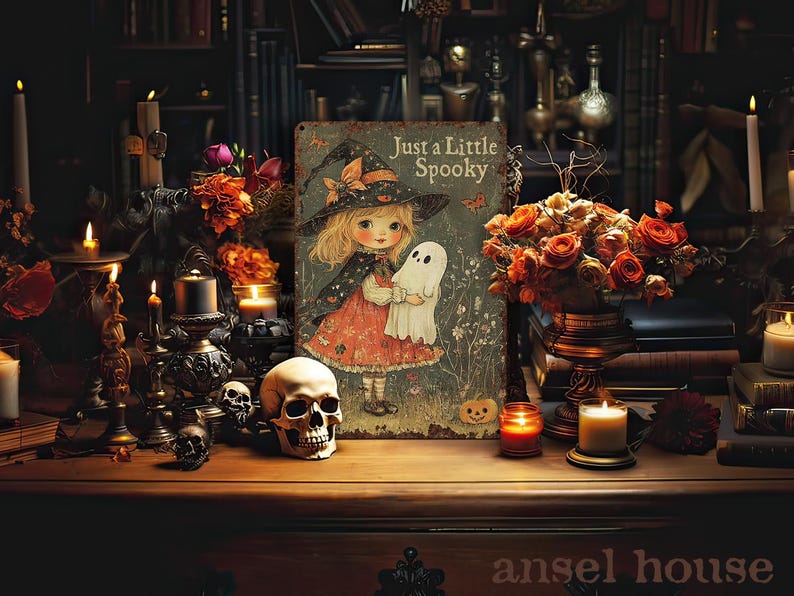 May include: A vintage-style Halloween scene with a sign that reads "Just a Little Spooky" featuring a girl in a witch hat holding a ghost. The scene includes candles, skulls, and a bouquet of orange roses, creating a spooky atmosphere.