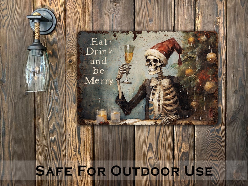 May include: A metal sign with a distressed, rusty look featuring a skeleton wearing a Santa hat and holding a glass of champagne. The sign reads "Eat, Drink and be Merry".