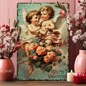 May include: Vintage-style metal sign with a romantic image of two cherubs with wings, holding flowers and surrounded by roses. The sign reads "To My Valentine".