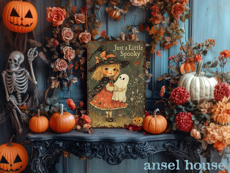 May include: A Halloween-themed display featuring a vintage-style illustration of a girl in a witch hat holding a ghost, with the text "Just a Little Spooky." The scene includes pumpkins, flowers, and a skeleton.