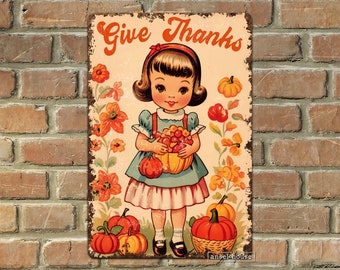 May include: A vintage-style metal sign with a girl holding a basket of fruit and pumpkins. The sign says "Give Thanks" and has a rustic, distressed look.