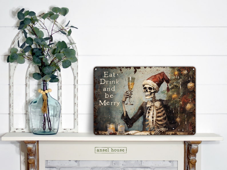 May include: A metal sign with a distressed, rusty look featuring a skeleton wearing a Santa hat and holding a glass of champagne. The sign reads "Eat, Drink and be Merry".