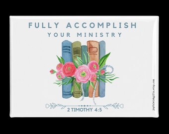 May include: A rectangular white magnet with the text "FULLY ACCOMPLISH YOUR MINISTRY" above a watercolor illustration of books and flowers. The bottom of the magnet reads "2 TIMOTHY 4:5". The books are blue, green, and brown, and the flowers are pink.
