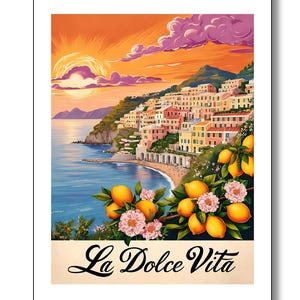 May include: A colorful illustration of a coastal town with a sunset in the background. The town is built on a cliff overlooking the ocean. There are lemon trees in the foreground with pink flowers and yellow lemons. The text "La Dolce Vita" is written in a cursive font at the bottom of the image.