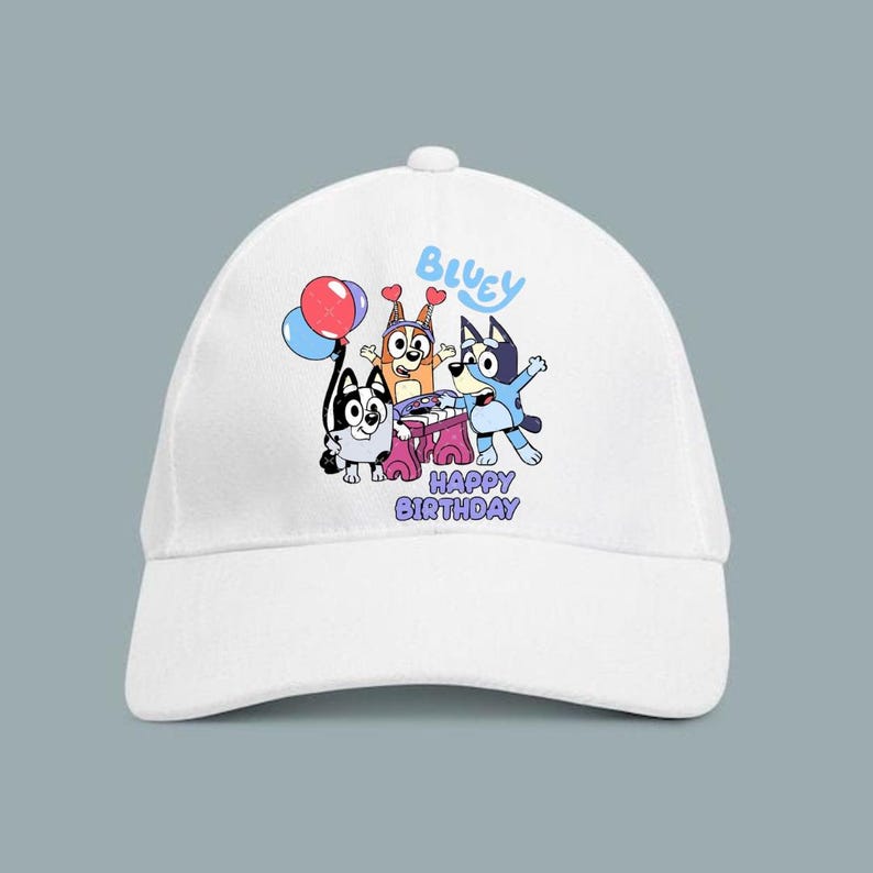 May include: White baseball cap featuring a colorful graphic of cartoon dogs with the text "Bluey" and "Happy Birthday". The design includes balloons and party hats, perfect for a birthday celebration.