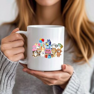 May include: White ceramic mug featuring a colorful cartoon illustration of various dog characters celebrating a birthday. The design includes a cake, balloons, and wrapped gifts, perfect for a fan of the animated series.