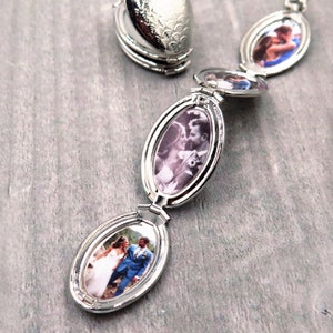 May include: A silver locket necklace with three oval-shaped photo compartments. Each compartment features a different photo of a couple.