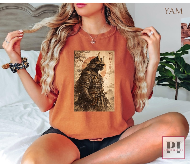 May include: Burnt orange t-shirt featuring a detailed graphic of a samurai warrior with a katana, set against a rising sun and Japanese text. The design is printed on a comfortable, casual tee, perfect for fans of Japanese culture and history.