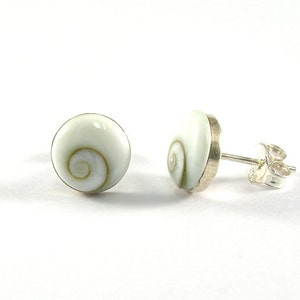 May include: A pair of silver stud earrings with white shell cabochons featuring a swirling green and brown pattern.