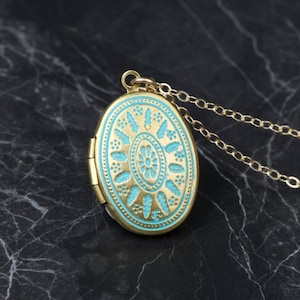 Small oval aqua blue and brass locketwith 14kt gold filled cable chain. Adorable and dainty.