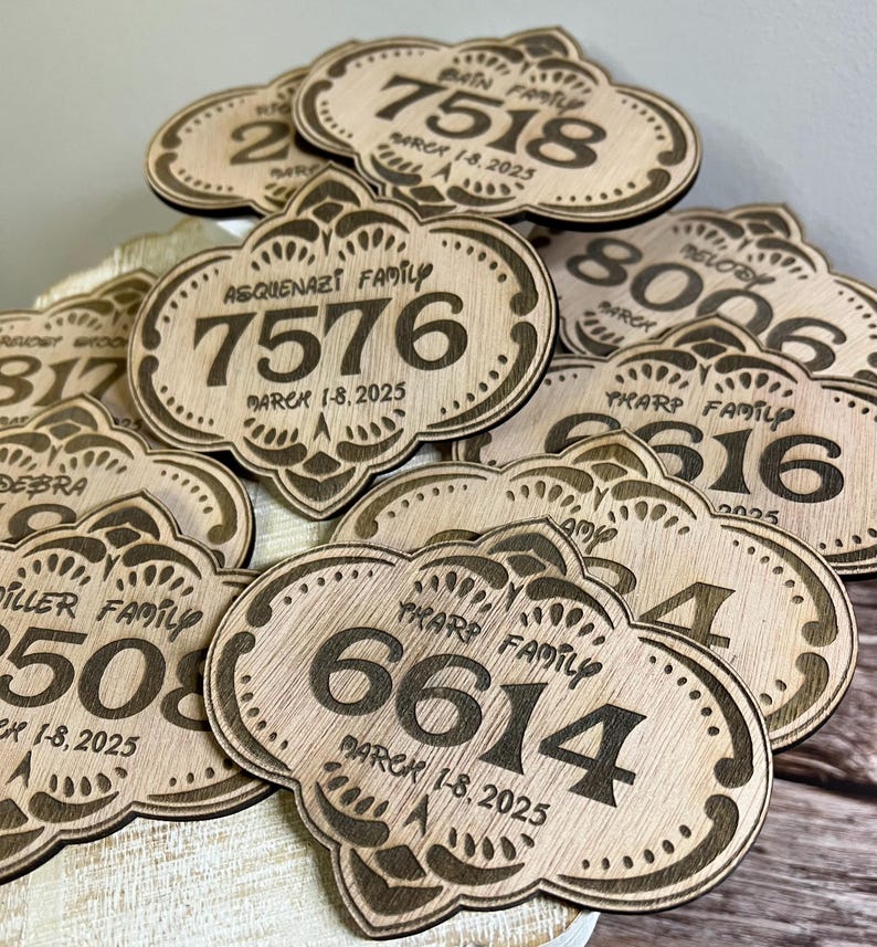 May include: A close-up of several wooden plaques with engraved family names, numbers, and the date "March 1-8, 2025".