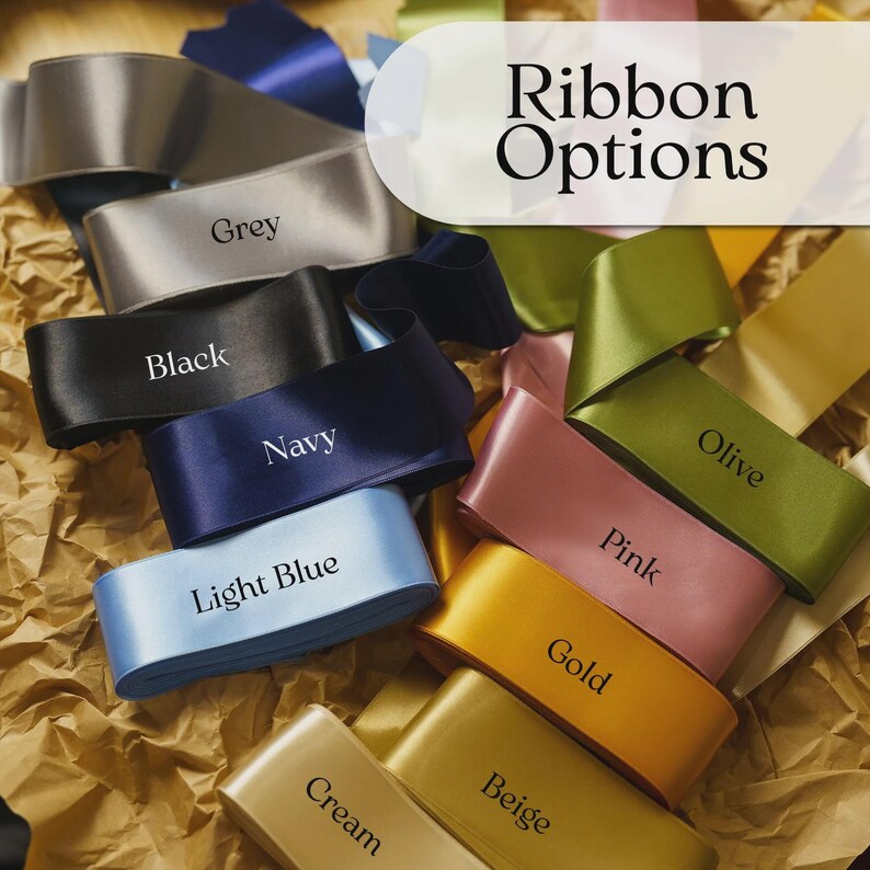 May include: A selection of satin ribbons in various colors, including grey, black, navy, light blue, olive, pink, gold, beige, and cream. Each ribbon is labeled with its color name. The image also features the text "Ribbon Options".