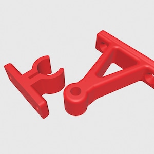 May include: Two bright red plastic brackets. One bracket has a curved holder, and the other has a triangular support with holes for mounting. The brackets are designed for structural support.