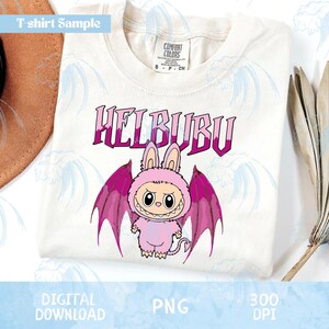 May include: White t-shirt with a cartoon character design. The design features a pink creature with bunny ears and bat wings, with the word "HELBUBU" in purple. The shirt also has the text "T-shirt Sample", "DIGITAL DOWNLOAD", "PNG", and "300 DPI".