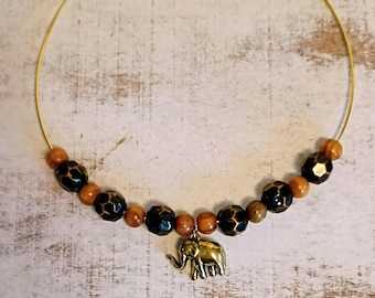 Collar necklace with elephant pendant.
