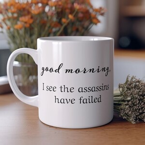 Good morning I see the assassins have failed sarcastic coffee mug, great holiday gift for friends or family
