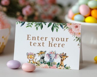 Può includere: Un biglietto pieghevole bianco con il testo "Enter your text here" in marrone, decorato con illustrazioni ad acquerello di una tigre, una zebra, un elefante e una giraffa con corone di fiori, foglie verdi e fiori rosa.