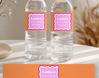 May include: Two clear plastic water bottles with orange labels featuring a pink scalloped frame. The text reads Louise's BRIDAL SHOWER 08.01.20XX. A separate orange label strip with the same design is displayed at the bottom of the image.