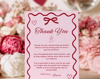 May include: A rectangular light pink thank you card with a dark red wavy border. The card features a dark red bow, two small hearts, and two champagne flutes. The text reads: Thank You, Thank you for celebrating my bridal shower and for being part of such a special moment. Your thoughtful gift, kind wishes, and loving support mean more than words can express. I'm so grateful to have you by my side as I begin this beautiful new chapter. Thank you for making the day so memorable. With love, Louise.