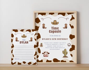 May include: A rectangular sign and a matching card featuring a brown and white cow print border. The sign reads Time Capsule to be opened on Dylan's 18th birthday, with illustrations of a cowboy hat, boots, a money bag, a cow, and a cactus.