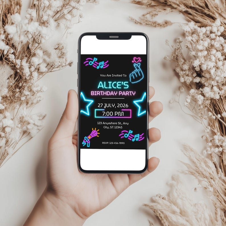 May include: A smartphone displaying a digital birthday party invitation with a black background and neon-style graphics including music notes, a heart-hand gesture, stars, and a microphone. The text reads: You Are Invited To ALICE'S BIRTHDAY PARTY 27 JULY, 2026 7:00 PM 123 Anywhere St., Any City, ST 12345 RSVP: 123-456-7890.