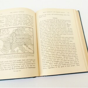 May include: A page from a history book showing a map of Europe with the borders of East and West Frankland highlighted in red. The text on the page discusses the history of the Frankish Empire and the rise of Germany and France.
