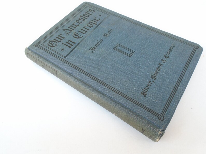 May include: A blue hardcover book titled "Our Ancestors in Europe" by Jennie Hall, published by Silver, Burdett & Company.