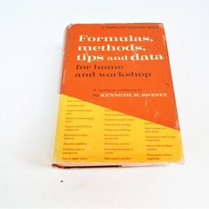 May include: An orange and yellow vintage book titled "Formulas, methods, tips and data for home and workshop." The book cover features white text and a list of topics. The book is a unique collection by Kenneth M. Swezey.