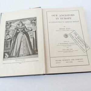 May include: An open book titled "Our Ancestors in Europe: An Introduction to American History" by Jennie Hall. The book is published by Silver, Burdett and Company. The cover features a black and white illustration of Queen Elizabeth I.