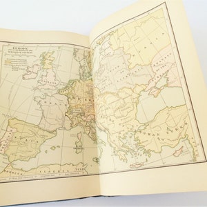 May include: A vintage map of Europe from the middle of the 18th century. The map shows the boundaries of various countries, including England, France, Spain, Germany, and Russia. The map is printed on a cream-colored paper with brown lines and text.