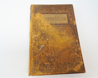 May include: A vintage, worn, brown leather-bound book with gold embossed lettering on the cover that reads "LONGFELLOW".